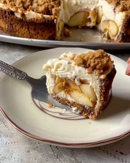 Apple Crumble Cheesecake 2 Slice of Apple Crumble Cheesecake topped with homemade apple filling and crumble.