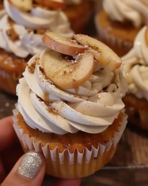 Apple Pie Cupcakes 2 Apple pie cupcakes topped with cinnamon frosting and apple slices