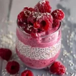 Delicious raspberry chia pudding topped with fresh raspberries and mint leaves.