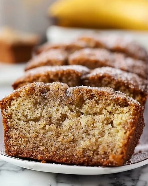 Loaf of freshly baked snickerdoodle banana bread topped with cinnamon sugar