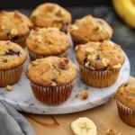 Freshly baked vegan banana muffins cooling on a wire rack