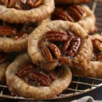 Delicious vegan pecan pie cookies on a rustic wooden table
