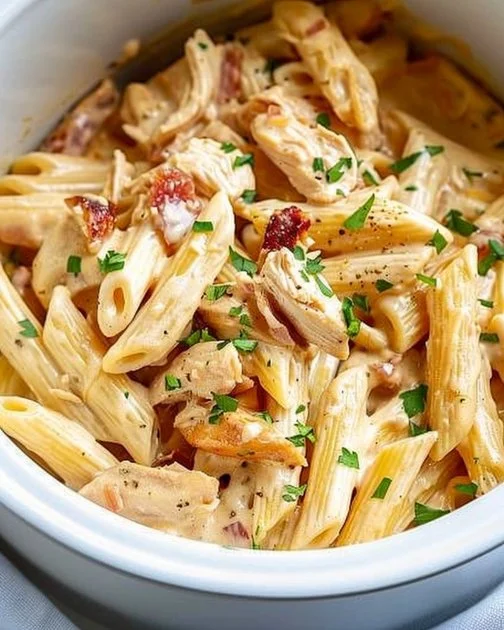 Crock Pot Creamy Cajun Chicken Pasta 7 Crock Pot Creamy Cajun Chicken Pasta in a bowl garnished with parsley