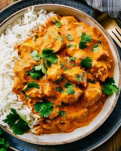 Delicious Crockpot Butter Chicken served with rice and cilantro
