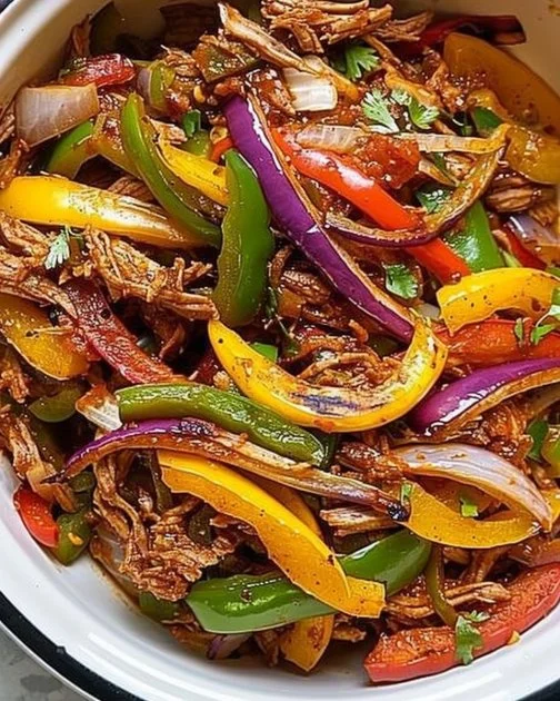 Crockpot Fajitas 2 Delicious Crockpot Fajitas served with peppers and onions in a bowl