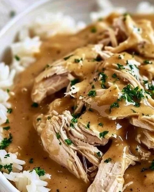Easy Crockpot Chicken and Gravy 2 Delicious serving of easy Crockpot chicken with gravy in a bowl