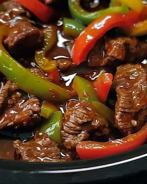 Pepper Steak in a Crock Pot 2 Delicious pepper steak prepared in a crock pot with colorful peppers and spices.