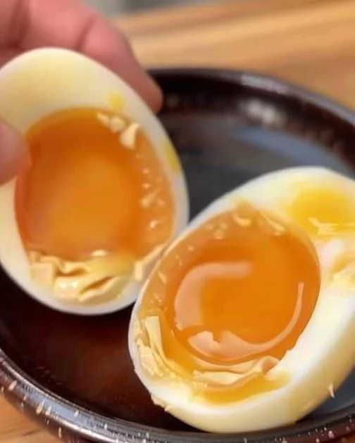 Savory Marinated Ramen Eggs 2 Savory marinated ramen eggs served in a bowl, ideal for ramen toppings.