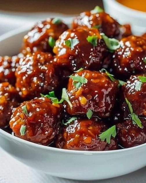 Sweet Chili Meatballs 9 Delicious sweet chili meatballs served on a platter with dipping sauce